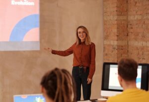 A woman with executive presence speaking at a work meeting.