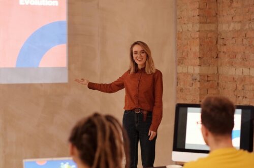 A woman with executive presence speaking at a work meeting.